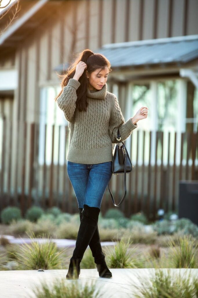 Display a close-up of ankle slouchy boots styled with rolled-up denim and a cozy sweater.